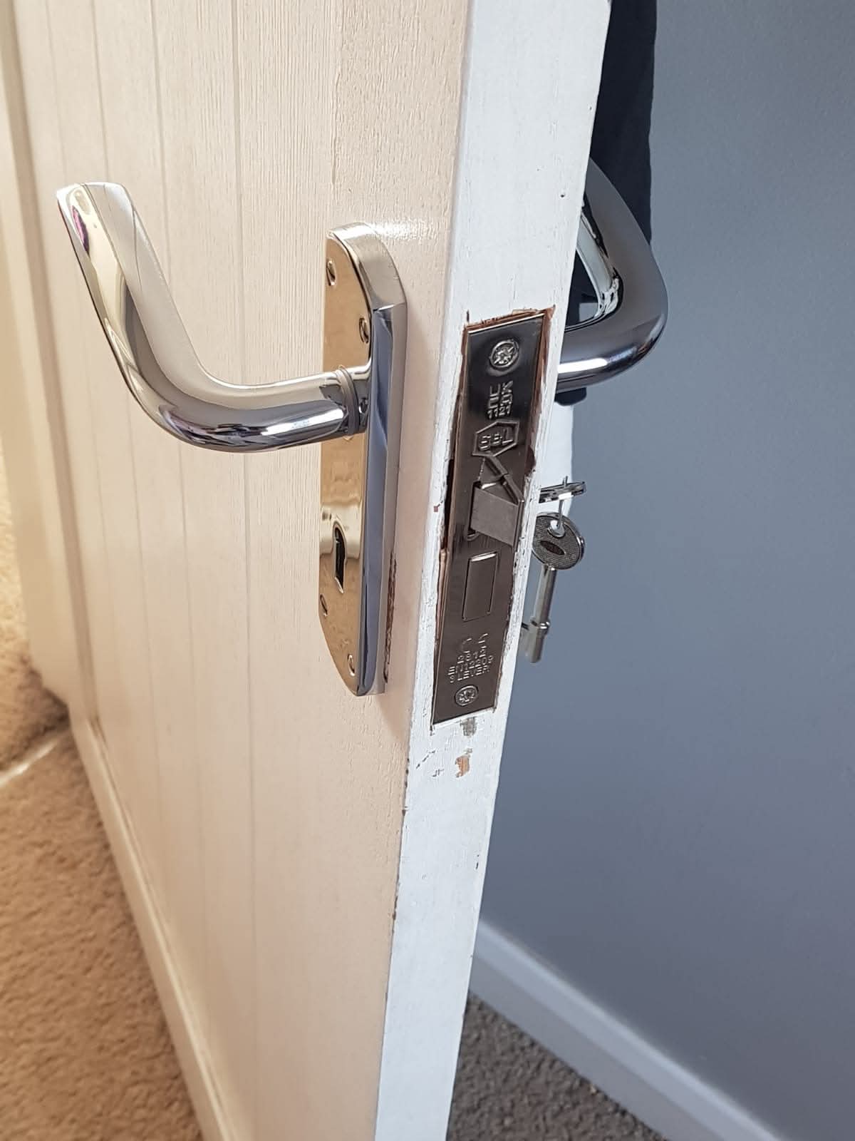 Chrome handle and mortice lock fitted to an internal door