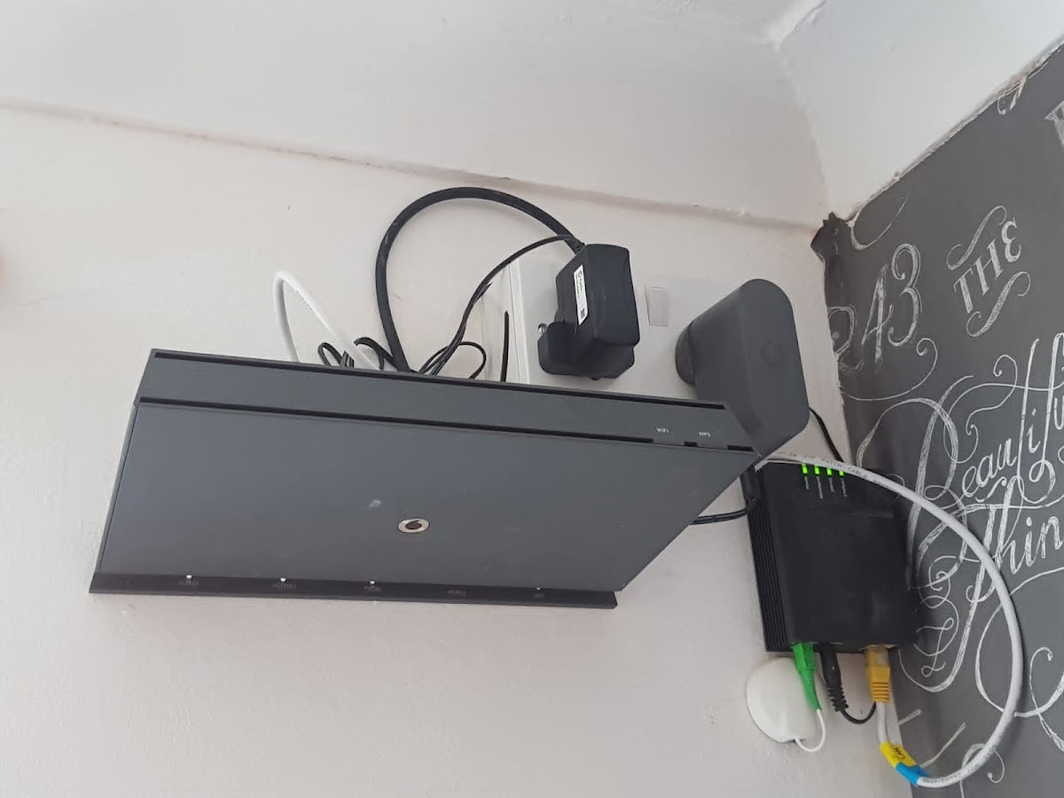 Router and cabling mounted and tidied on a wall